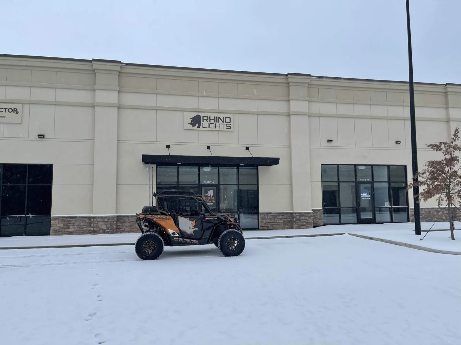 The Rhino Lights unit in Huntersville, North Carolina, its illuminated sign lit with a wrapped Can-Am parked outside